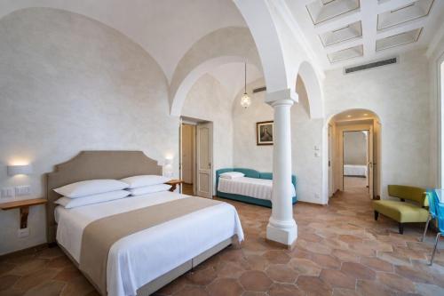 a bedroom with a bed and a room with two beds at Hotiday Positano Volte Alte in Positano