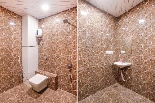 a bathroom with a toilet and a shower and a sink at FabHotel Vishwas in Aurangabad
