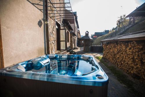 a blue tub sitting outside of a building at Dolce Vita in Bukovel