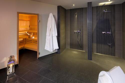 a bathroom with a walk in shower and a sink at ACHAT Hotel Braunschweig in Braunschweig