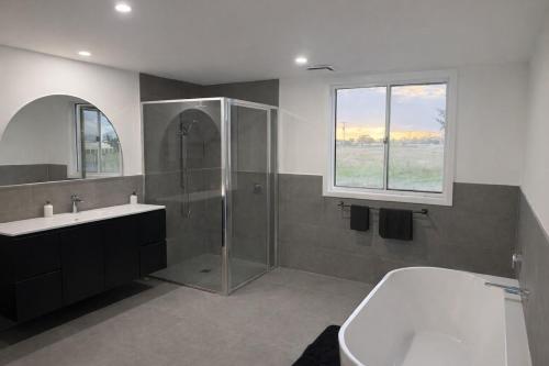 a bathroom with a shower and a toilet and a sink at Agnes homestead in Welshpool