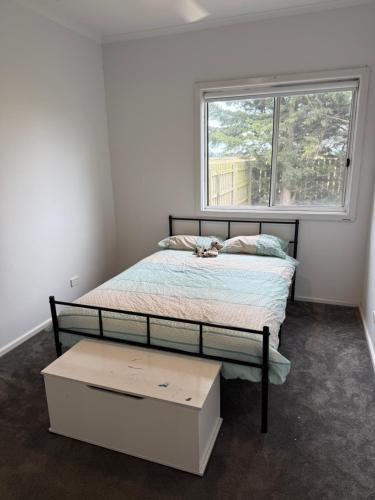 a small bedroom with a bed with a window at Agnes homestead in Welshpool