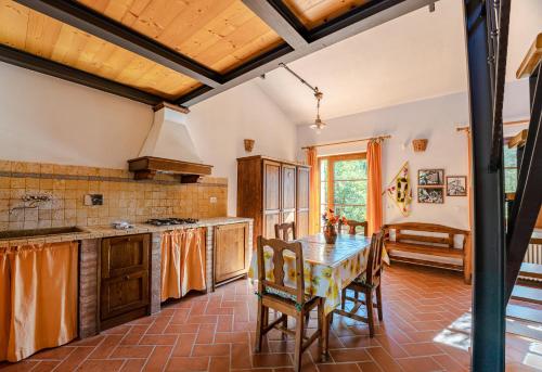 a kitchen with a table and chairs in a room at Agriturismo Bike Hotel Podere Giarlinga in Massa Marittima