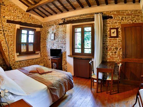 a bedroom with a bed and a brick wall at Agriturismo Case Mori in Rimini