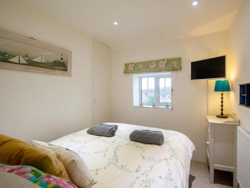 a bedroom with a bed and a window at 3 Bed in Bridport oc-dc080 in Charmouth