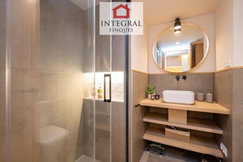 a bathroom with a shower and a sink and a mirror at Horitzó Marí Palamós in Palamós
