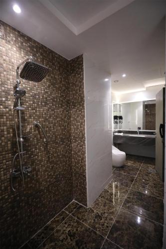 a bathroom with a shower and a toilet at Best Western Premier Riyadh in Riyadh