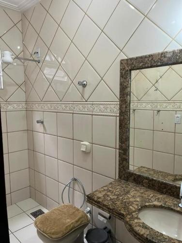 a bathroom with a sink and a mirror at Casa nova 2 quartos in Montes Claros
