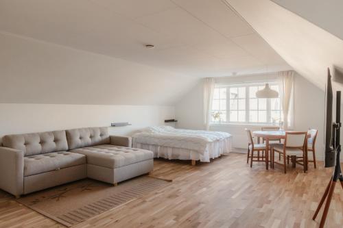 a bedroom with a couch and a bed and a table at Äleklinta in Äleklinta