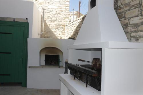 a fireplace in a building with a green door at To Konatzi tis Marikas tzai tou Yianni in Kato Drys