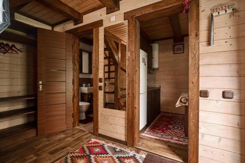 a bathroom with wooden walls and a toilet in a room at Family Plai in Yaremche