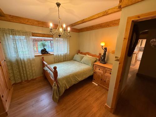a bedroom with a bed and a window at Detached property, beams, hot tub large garden in Broadwey