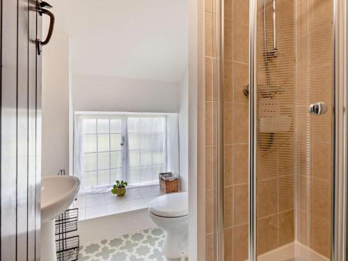 a bathroom with a toilet and a glass shower at 2 Bed in Minehead oc-90924 in Minehead