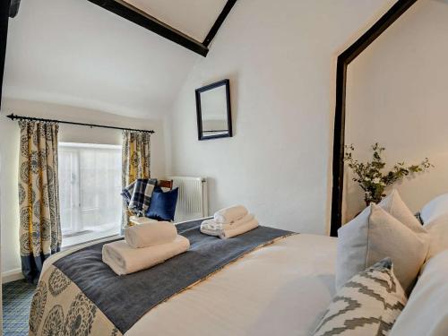 a bedroom with a large bed with two towels on it at 2 Bed in Minehead oc-90924 in Minehead