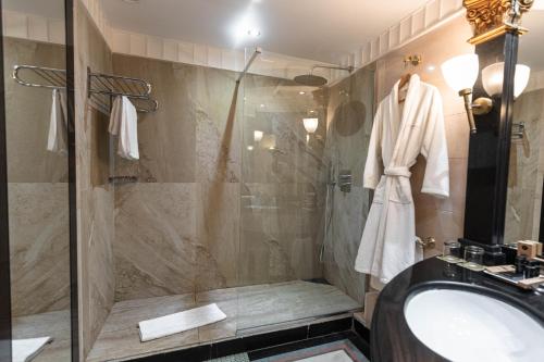 a bathroom with a shower and a sink at Golden Carthage Hotel & Residence Tunis in Gammarth