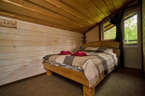 a bedroom with a bed in a log cabin at Family Plai in Yaremche