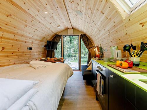 a bedroom with a large bed in a wooden room at 2 Bed in Okehampton oc-92385 in Okehampton