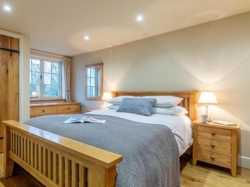 a bedroom with a large bed with blue pillows at 3 Bed in Axminster oc-bloco in Axminster