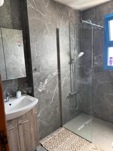 a bathroom with a glass shower and a sink at QUEEN EVRIDIKI & VILLA PANORAMA in Peyia