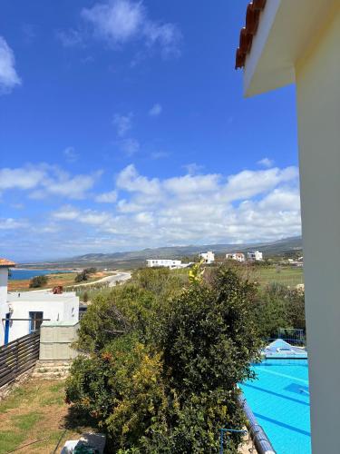 a view of a swimming pool from a house at QUEEN EVRIDIKI & VILLA PANORAMA in Peyia