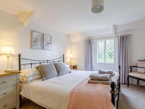 a bedroom with a large bed and a window at 1 Bed in Chulmleigh oc-82389 in Chulmleigh