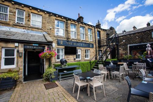 a restaurant with tables and chairs in front of a building at The Black Hat in Ilkley