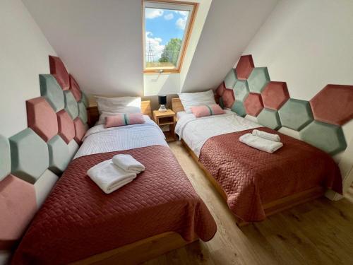 a room with two beds and a window at Ulinia Zacisze Dom Comfort 70m2 in Ulinia