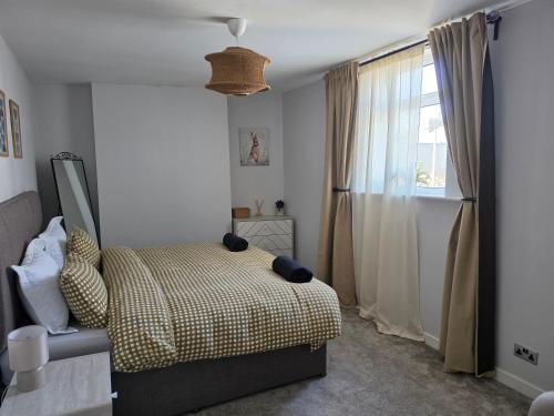 a bedroom with a bed and a window at Ample town house in Workington, West Lakes, Lake District in Workington