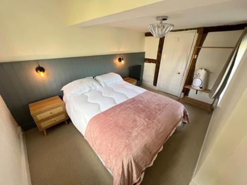 a bedroom with a large bed and a window at Habberley Hall Flat in Shrewsbury