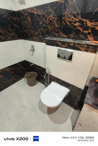 a bathroom with a toilet in a wall at Dev Hotel & Restaurant in Vrindāvan