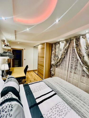 a bedroom with a bed and a desk and curtains at Arnie in Longley