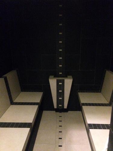 three empty benches in a dark room at Hotel Panství Dlouhá Lhota in Dlouhá Lhota