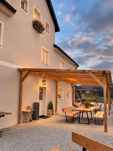 a patio with a table and benches in front of a house at Bio Hof Bichler in Mariazell