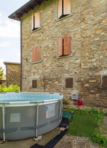 a bath tub in front of a stone building at Perbone 1573 - Premium Restored Villa in Toano