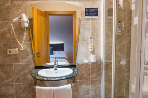 a bathroom with a sink and a shower at Alda Carballo in Carballo