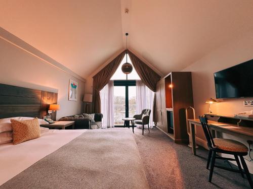 a large room with a bed and a living room at The Swan, Streatley, Berkshire in Streatley