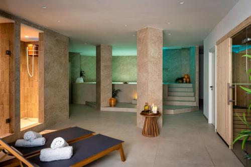 a bathroom with a shower and a table in a room at FERGUS Style Palma Beach - Adults Only in Can Pastilla
