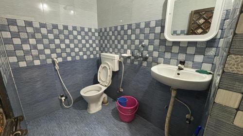 a bathroom with a toilet and a sink at Subhash Guest House in Gaya