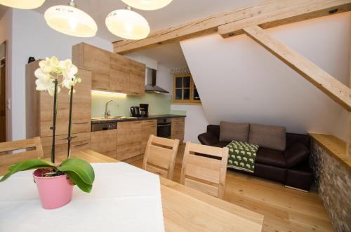 a kitchen and living room with a table and a couch at Ferienwohnungen Flattnerhof in Mauterndorf