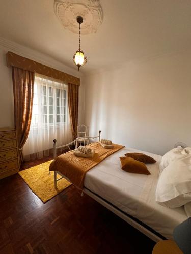a bedroom with a large bed and a window at Azor International House in Ponta Delgada