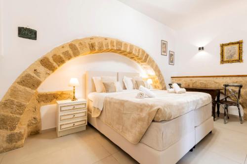 a bedroom with a bed in a room with an arch at Kristina´s rooms in Rhodes Town