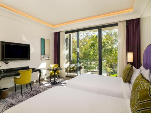 a bedroom with a large white bed and a desk at STORY Rabat in Rabat