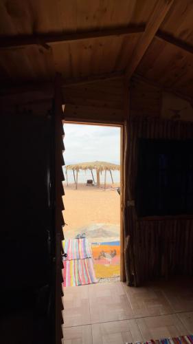 a room with a view of the beach through a door at Anne in Nuweiba