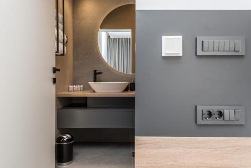 a bathroom with a sink and a mirror at Villa Aria in Novalja