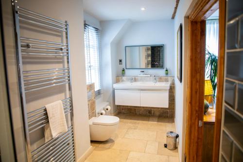 a bathroom with a toilet and a sink at The Chalk Hare, Royston, Hertfordshire - Acorn Pubs in Royston