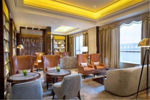 a living room with chairs and tables and a lobby at Sofitel Shanghai Hongqiao in Shanghai