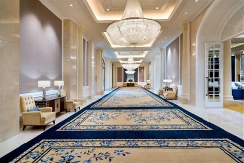 a large hallway with a large rug in a building at Sofitel Shanghai Hongqiao in Shanghai