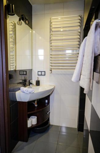 a bathroom with a sink and a shower at Apartament nad Bukówką in Lubawka