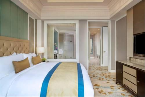 a bedroom with a large bed and a television at Sofitel Shanghai Hongqiao in Shanghai
