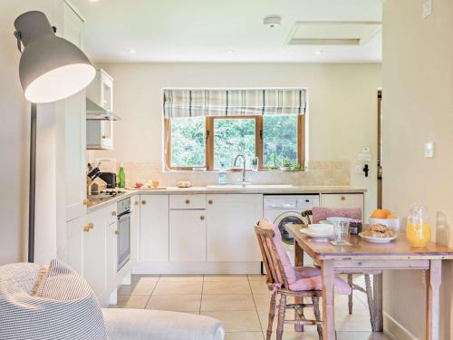 a kitchen with a table and a dining room at 1 Bed in Bampton oc-limkc in Bampton